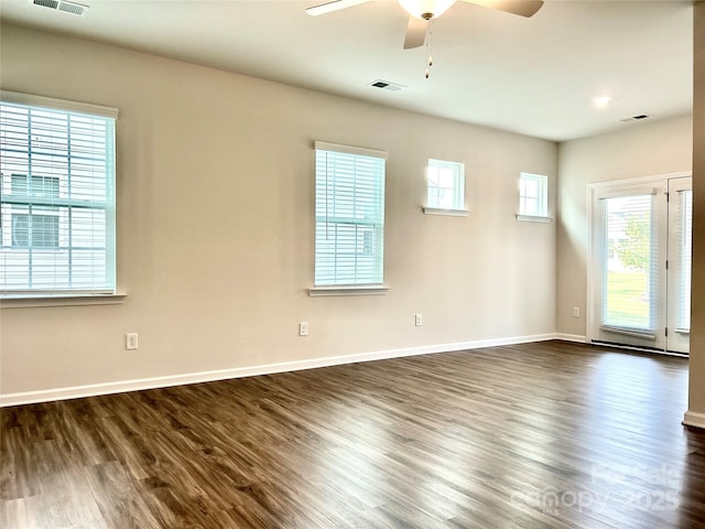 unfurnished room with ceiling fan, dark hardwood / wood-style flooring, and plenty of natural light