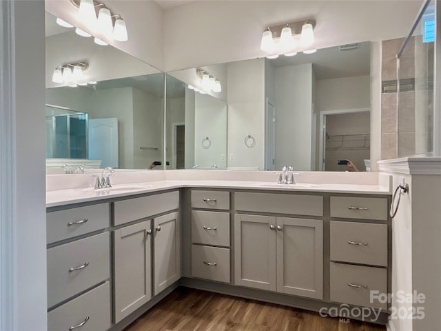 bathroom featuring a shower, vanity, and hardwood / wood-style flooring