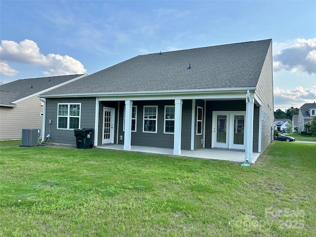 back of property featuring central AC, a patio area, and a yard