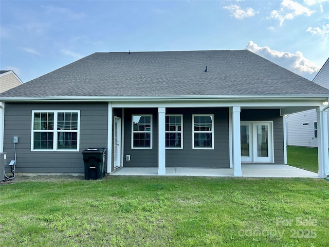 back of property featuring a lawn and a patio