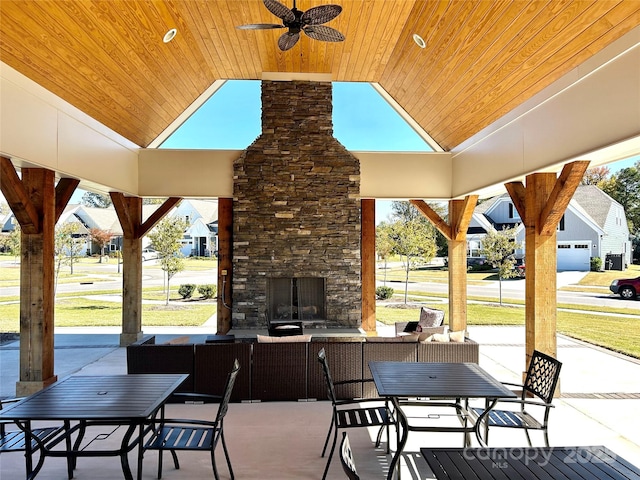 view of patio featuring an outdoor living space with a fireplace and ceiling fan