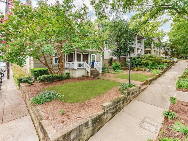 exterior space with a front yard and covered porch