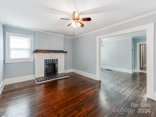 unfurnished living room featuring ornamental molding, a tile fireplace, dark hardwood / wood-style floors, and ceiling fan