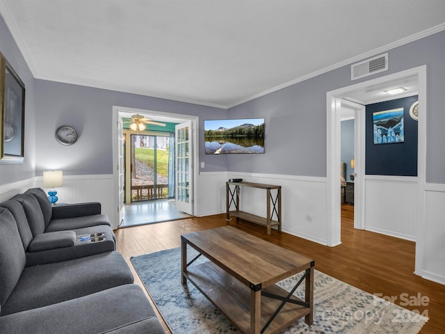 living room with crown molding, ceiling fan, and hardwood / wood-style floors