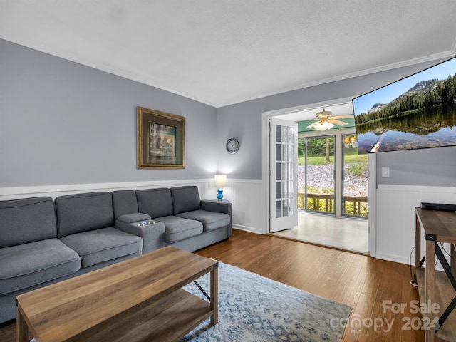 living room featuring ceiling fan, hardwood / wood-style flooring, and ornamental molding