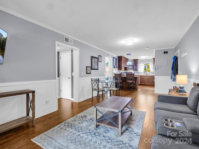 living room featuring ornamental molding and dark hardwood / wood-style floors