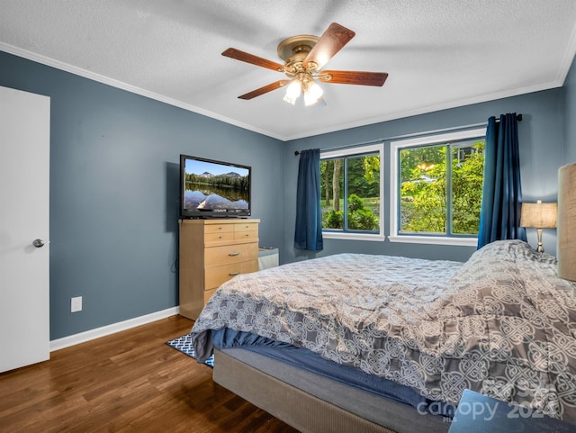 bedroom featuring a textured ceiling, ornamental molding, dark hardwood / wood-style floors, and ceiling fan