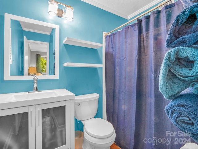 bathroom with vanity, toilet, and ornamental molding