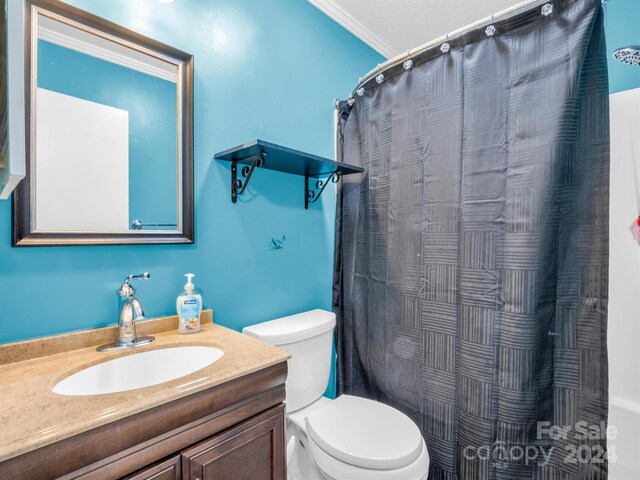 bathroom featuring vanity, a textured ceiling, toilet, and crown molding