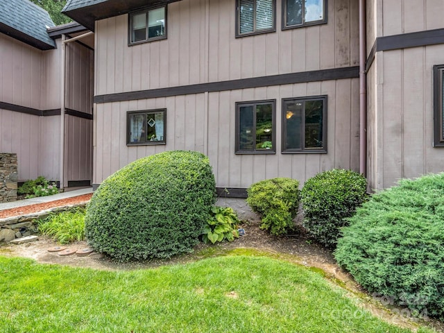 view of exterior entry featuring a yard