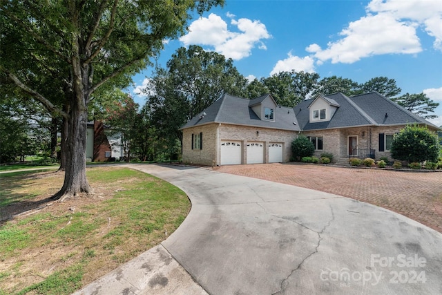 view of front of home featuring a garage and a front lawn