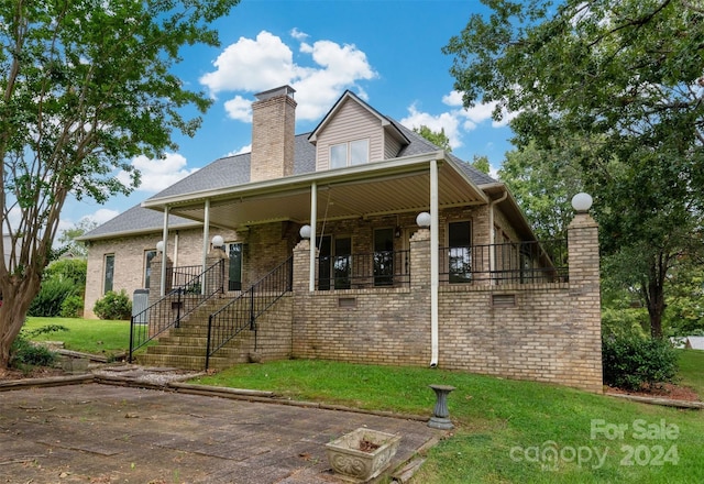 rear view of house with a yard