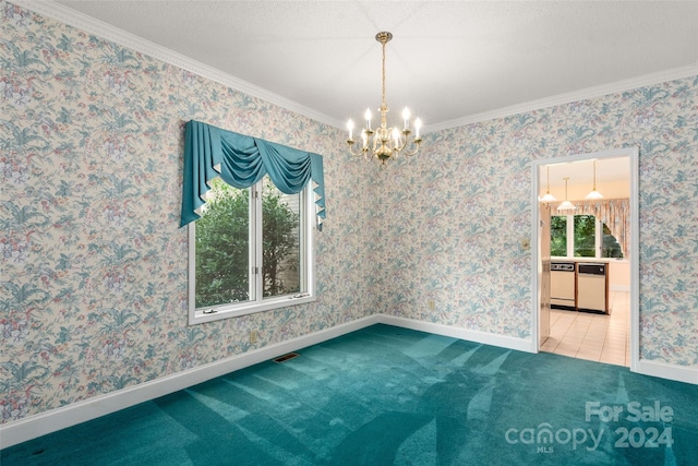 carpeted spare room with ornamental molding and an inviting chandelier