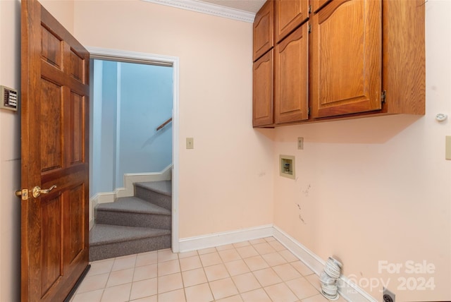 washroom with cabinets, washer hookup, light tile patterned floors, and ornamental molding