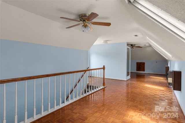 bonus room with a textured ceiling, ceiling fan, lofted ceiling, and light parquet flooring