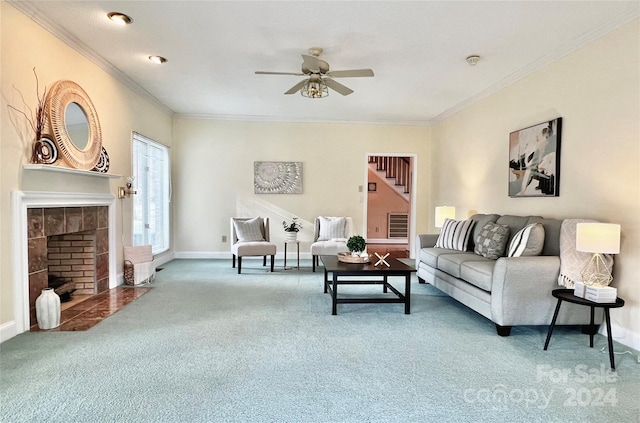 living room with ceiling fan, carpet floors, a fireplace, and ornamental molding