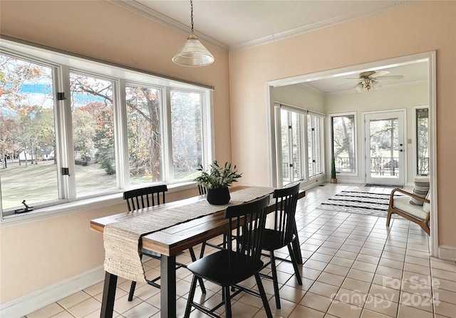 tiled dining room featuring ceiling fan and crown molding