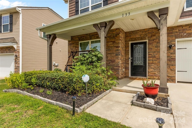 property entrance featuring a porch and a garage