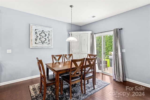 dining area featuring dark wood-style floors, baseboards, and visible vents