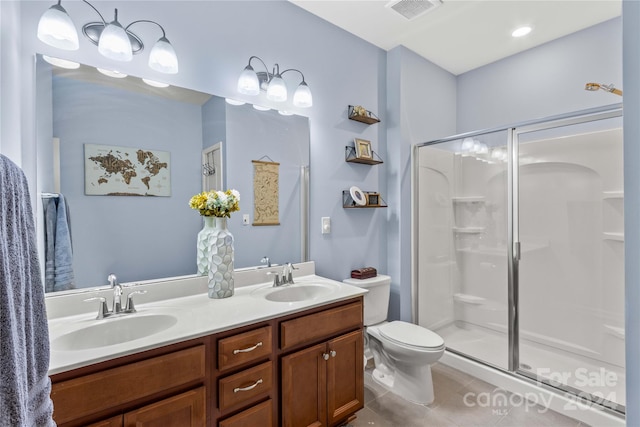 full bathroom with double vanity, a sink, visible vents, and a shower stall