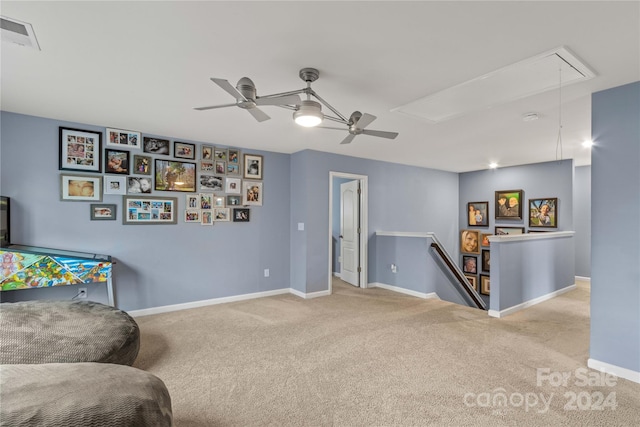 living area with light carpet, visible vents, an upstairs landing, baseboards, and attic access