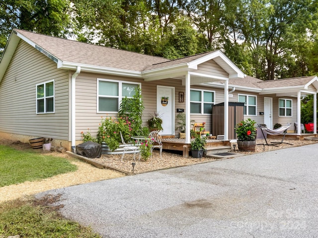 single story home with roof with shingles