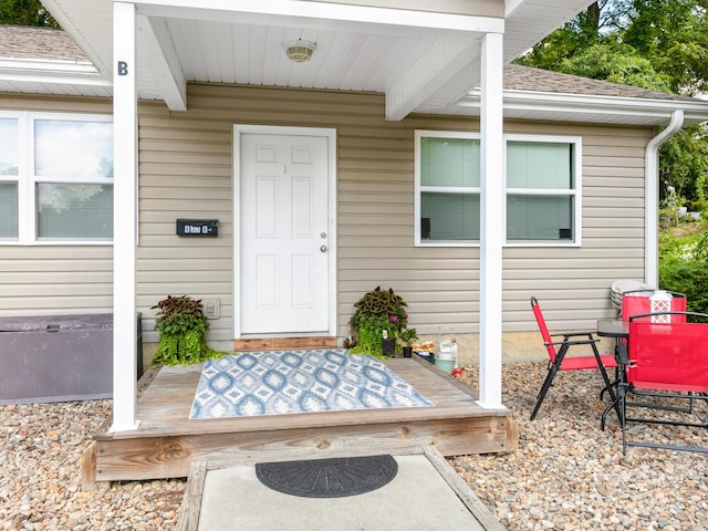 entrance to property with a shingled roof