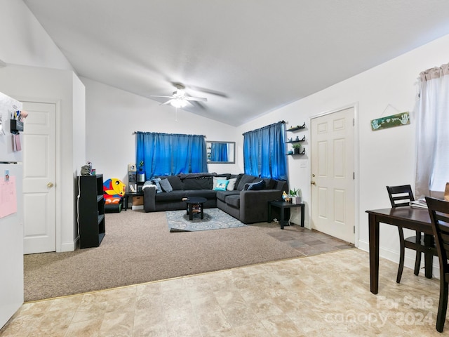 living area with lofted ceiling, ceiling fan, and light carpet