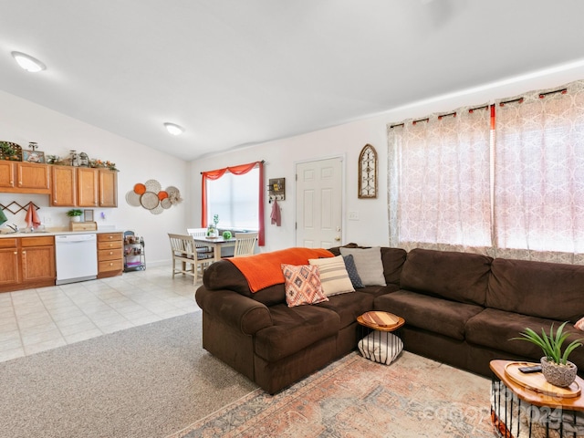 living area with vaulted ceiling, light tile patterned floors, and light carpet