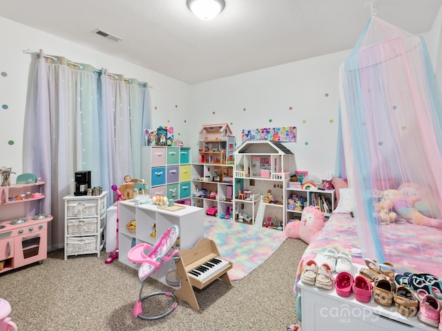 carpeted bedroom featuring visible vents