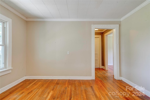 unfurnished room with light hardwood / wood-style flooring and ornamental molding