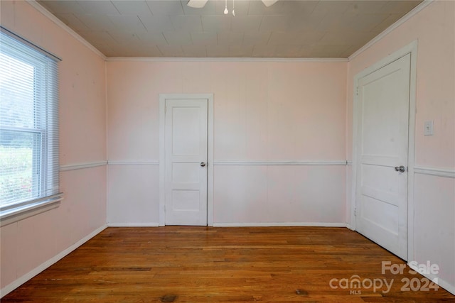 unfurnished room featuring ceiling fan, hardwood / wood-style flooring, and crown molding