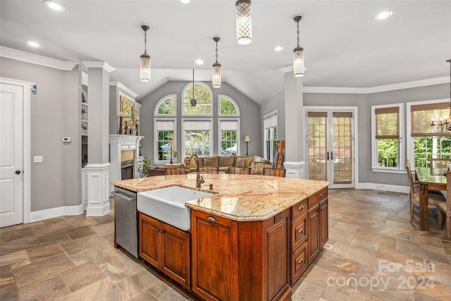 kitchen featuring a kitchen island with sink, light tile patterned flooring, sink, stainless steel dishwasher, and light stone counters