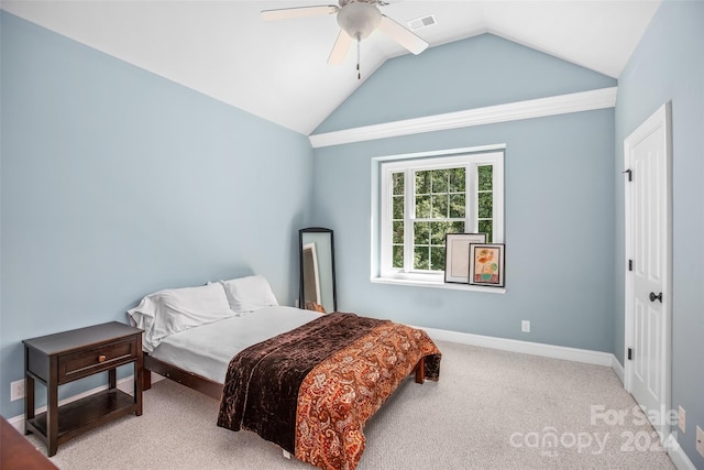 bedroom with ceiling fan, lofted ceiling, and carpet