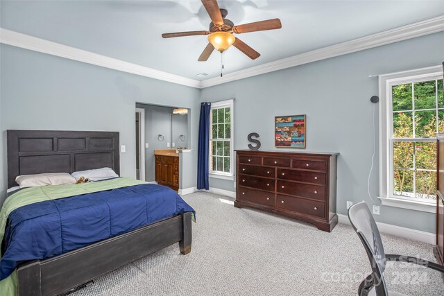 bedroom featuring ceiling fan, crown molding, and light colored carpet