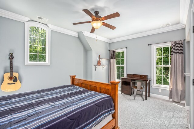 carpeted bedroom with ceiling fan and ornamental molding