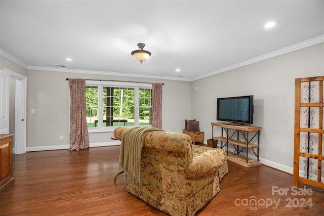 living room with dark wood-type flooring and crown molding