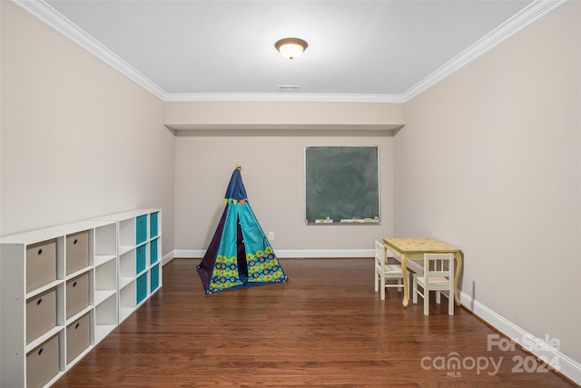 recreation room featuring wood-type flooring and ornamental molding