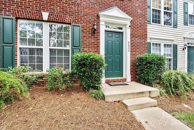 property entrance with brick siding