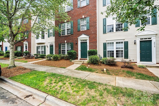 view of property featuring brick siding