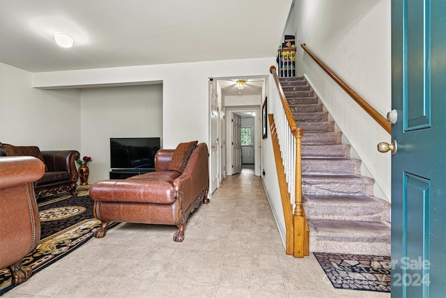 tiled living room with ceiling fan