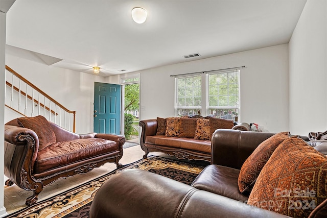 living area featuring stairway, carpet flooring, and visible vents