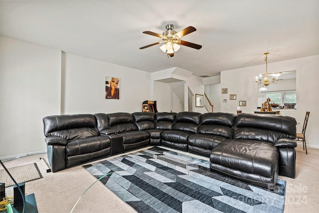 living area featuring ceiling fan with notable chandelier, carpet floors, stairway, and baseboards