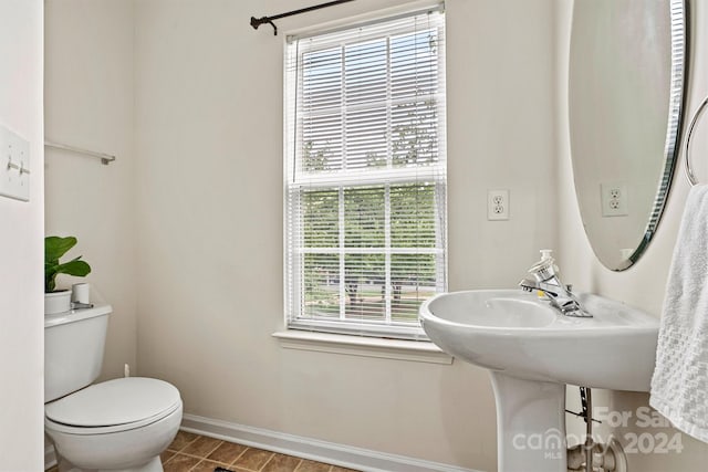 bathroom with toilet and tile patterned floors