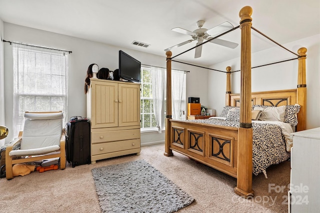 carpeted bedroom with ceiling fan and visible vents