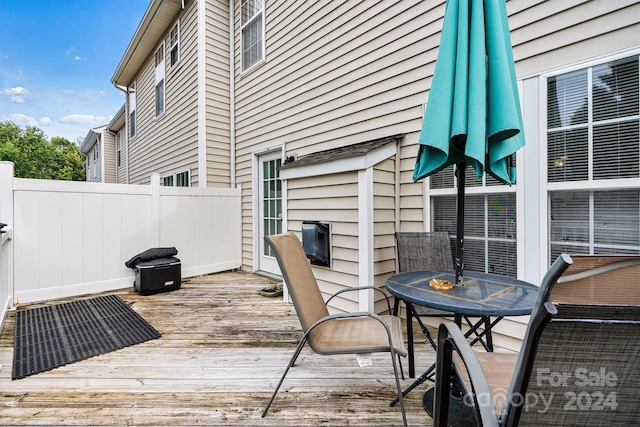 wooden deck featuring outdoor dining space and fence