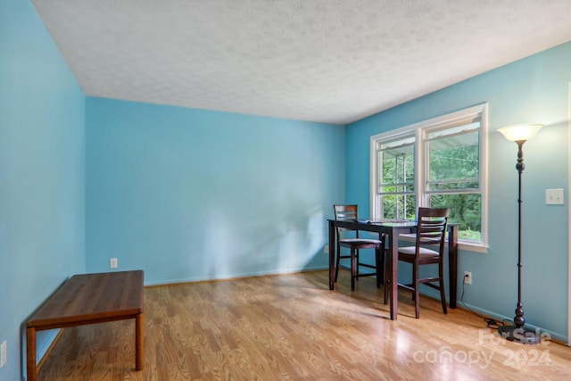 office space featuring a textured ceiling and hardwood / wood-style floors