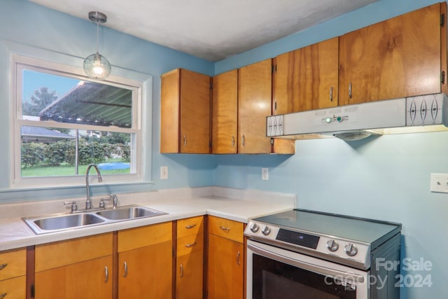 kitchen with sink, electric range, custom range hood, and decorative light fixtures