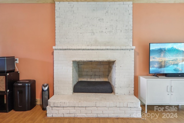 details with hardwood / wood-style flooring and a fireplace