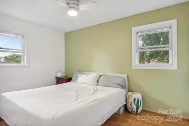 bedroom with ceiling fan and dark hardwood / wood-style floors